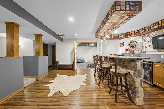 216 Deforest Dr, Kaukauna, WI 54130 - indoor wet bar featuring beverage cooler, dark wood-style flooring, recessed lighting, and baseboards