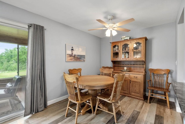 348 County Road B 8, Fontana, WI 53125 - dining area with light wood-type flooring, a ceiling fan, and baseboards