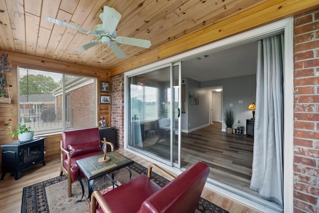 348 County Road B 8, Fontana, WI 53125 - sunroom / solarium with a wood stove and plenty of natural light