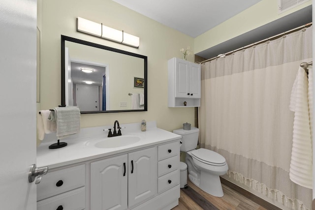 348 County Road B 8, Fontana, WI 53125 - bathroom with toilet, vanity, wood finished floors, and curtained shower