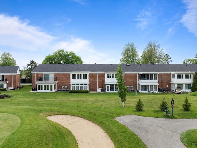 348 County Road B 8, Fontana, WI 53125 - view of front of property with brick siding, a front lawn, and driveway