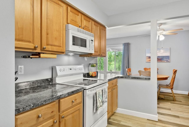 348 County Road B 8, Fontana, WI 53125 - kitchen with white appliances, light wood-style flooring, a ceiling fan, baseboards, and dark stone counters