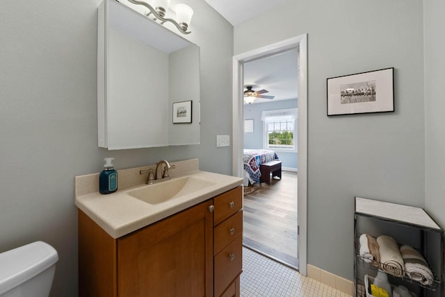 348 County Road B 8, Fontana, WI 53125 - bathroom featuring vanity, toilet, ceiling fan, and baseboards
