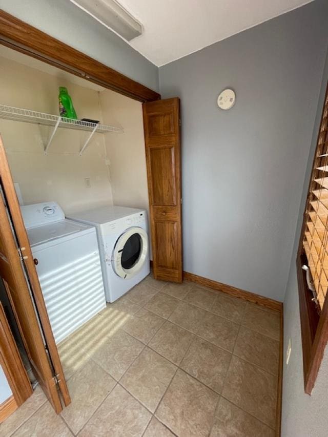120 Hudson St, Antigo, WI 54409 - washroom with washer and clothes dryer, light tile patterned floors, and baseboards