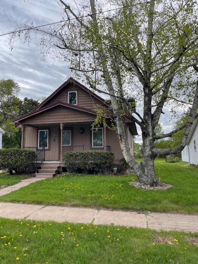 120 Hudson St, Antigo, WI 54409 - bungalow featuring covered porch and a front lawn