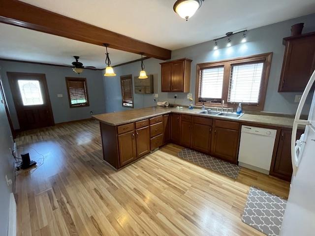 120 Hudson St, Antigo, WI 54409 - kitchen with dishwasher, a sink, a peninsula, light wood-style flooring, and plenty of natural light