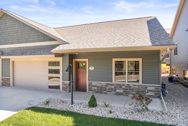 28 Sienna Hills Cir, Mount Horeb, WI 53572 - craftsman house with covered porch, a garage, stone siding, concrete driveway, and a shingled roof