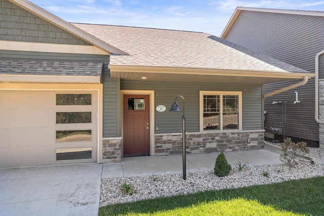 28 Sienna Hills Cir, Mount Horeb, WI 53572 - property entrance featuring roof with shingles, stone siding, and covered porch