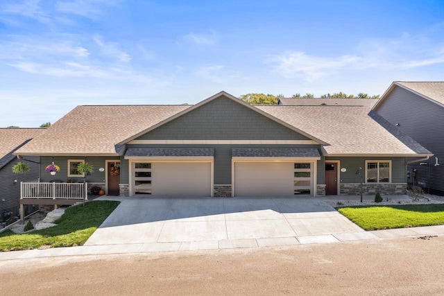 28 Sienna Hills Cir, Mount Horeb, WI 53572 - view of front of house with a garage, stone siding, concrete driveway, roof with shingles, and a front yard
