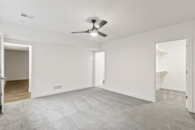 28 Sienna Hills Cir, Mount Horeb, WI 53572 - unfurnished bedroom with carpet flooring, baseboards, ceiling fan, and a spacious closet