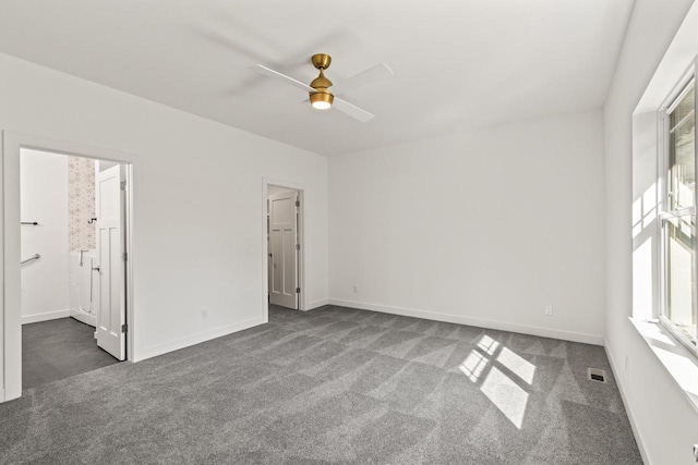 28 Sienna Hills Cir, Mount Horeb, WI 53572 - empty room with dark carpet, ceiling fan, and baseboards