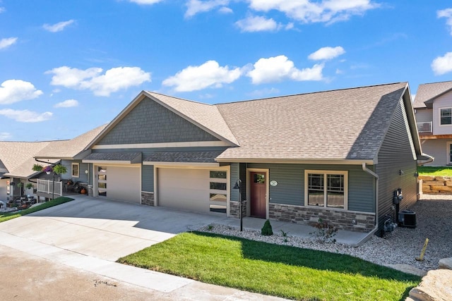 28 Sienna Hills Cir, Mount Horeb, WI 53572 - craftsman inspired home with an attached garage, stone siding, central AC unit, concrete driveway, and a shingled roof