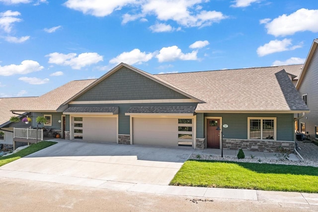 28 Sienna Hills Cir, Mount Horeb, WI 53572 - craftsman-style house with stone siding, a garage, concrete driveway, and a front yard