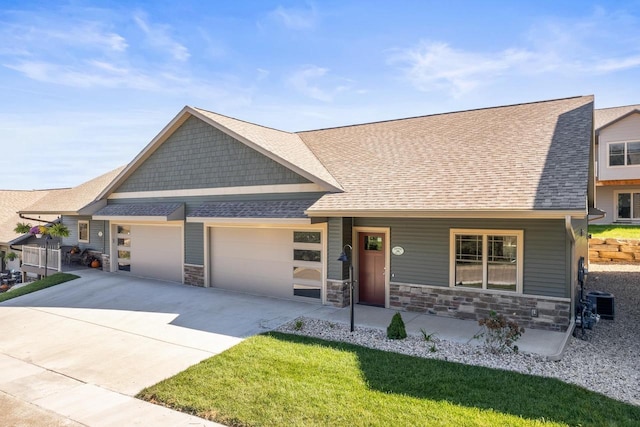28 Sienna Hills Cir, Mount Horeb, WI 53572 - craftsman inspired home with a garage, concrete driveway, stone siding, and covered porch