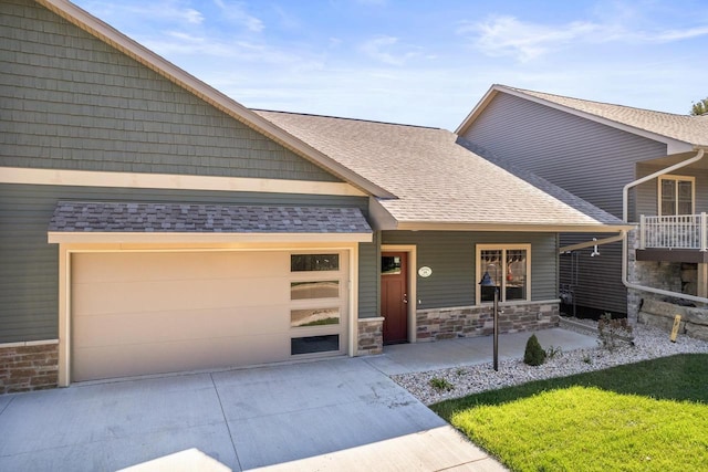 28 Sienna Hills Cir, Mount Horeb, WI 53572 - view of front of property featuring concrete driveway, a shingled roof, stone siding, a garage, and a porch