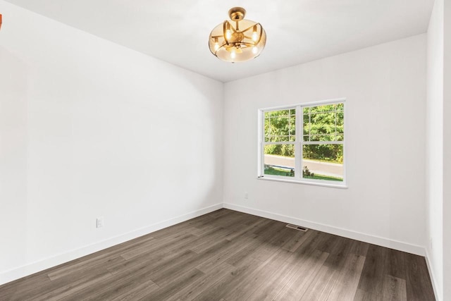 28 Sienna Hills Cir, Mount Horeb, WI 53572 - empty room with a chandelier, dark wood-style floors, and baseboards
