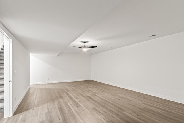 28 Sienna Hills Cir, Mount Horeb, WI 53572 - empty room with stairs, wood finished floors, baseboards, and a ceiling fan