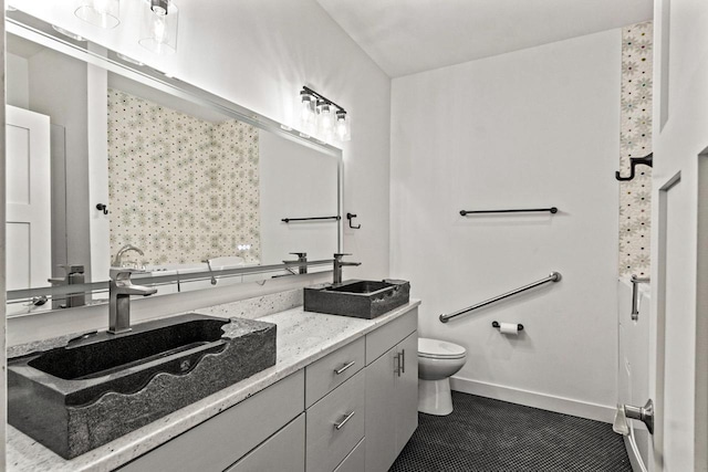 28 Sienna Hills Cir, Mount Horeb, WI 53572 - bathroom featuring double vanity, toilet, baseboards, and tile patterned floors