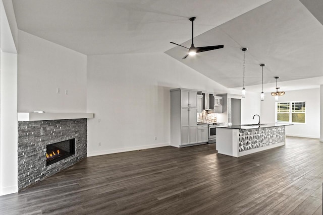 28 Sienna Hills Cir, Mount Horeb, WI 53572 - unfurnished living room featuring a stone fireplace, dark wood-type flooring, baseboards, high vaulted ceiling, and a ceiling fan