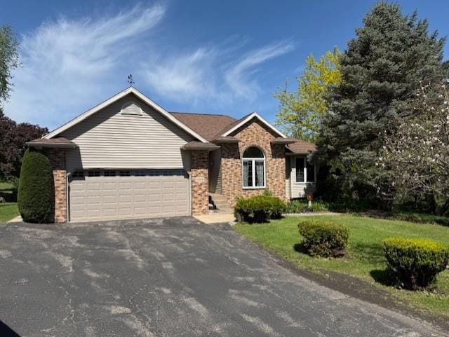 3108 Hawks Haven Trl, Deforest, WI 53532 - ranch-style home with a garage, asphalt driveway, a front yard, and brick siding