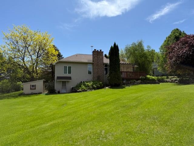 3108 Hawks Haven Trl, Deforest, WI 53532 - rear view of property with a lawn and a chimney