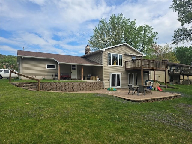 2626 Abbe Hill Dr, Eau Claire, WI 54703 - rear view of property featuring a chimney, a lawn, a wooden deck, and a patio area