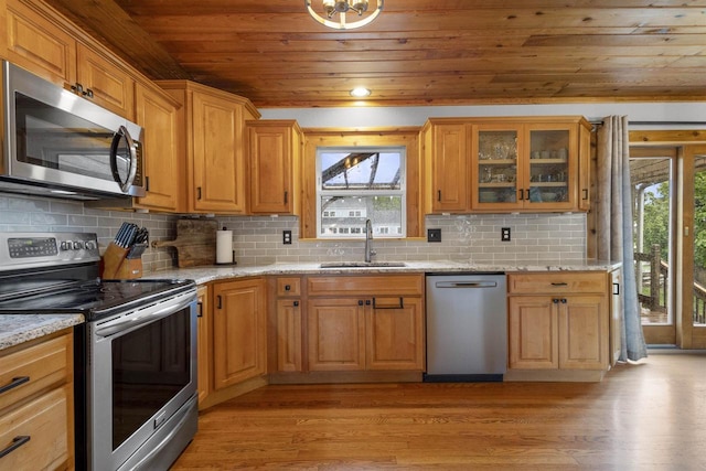 2104 Hazel St, Oshkosh, WI 54901 - kitchen featuring stainless steel appliances, a sink, wooden ceiling, light wood finished floors, and light stone countertops