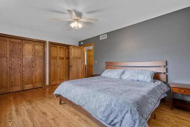 2104 Hazel St, Oshkosh, WI 54901 - bedroom featuring light wood-style flooring, multiple closets, and a ceiling fan