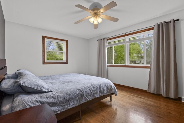 2104 Hazel St, Oshkosh, WI 54901 - bedroom with multiple windows, wood finished floors, baseboards, and ceiling fan