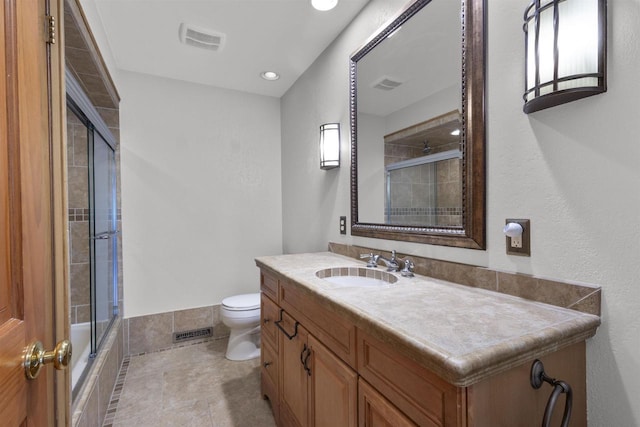 2104 Hazel St, Oshkosh, WI 54901 - bathroom with toilet, vanity, recessed lighting, shower / bath combination with glass door, and tile patterned floors