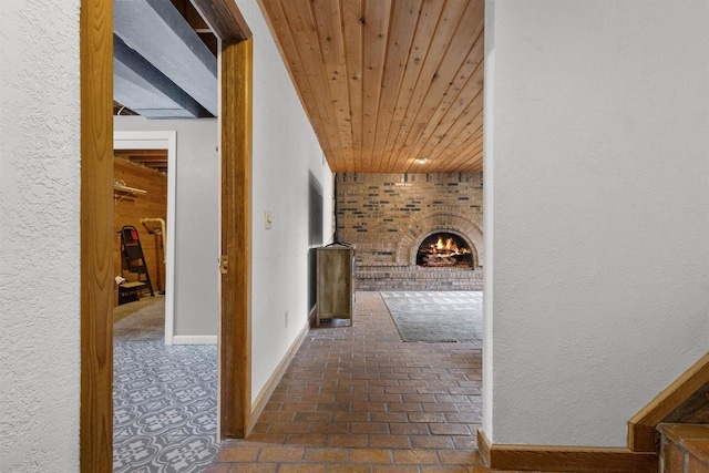 2104 Hazel St, Oshkosh, WI 54901 - hallway featuring wood ceiling, baseboards, brick floors, and a textured wall