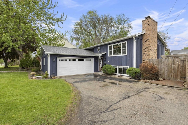 2104 Hazel St, Oshkosh, WI 54901 - view of front of home featuring a chimney, a garage, and driveway