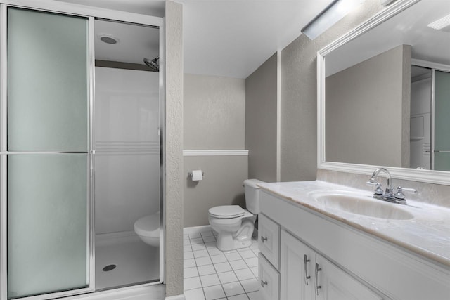 2104 Hazel St, Oshkosh, WI 54901 - bathroom featuring toilet, tile patterned floors, vanity, a stall shower, and a textured wall