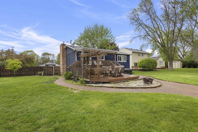 2104 Hazel St, Oshkosh, WI 54901 - rear view of house with an outdoor fire pit, a deck, a pergola, and a chimney