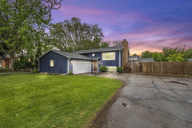 2104 Hazel St, Oshkosh, WI 54901 - view of front of home featuring asphalt driveway, a chimney, and an attached garage