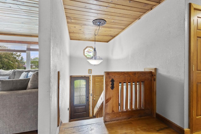 2104 Hazel St, Oshkosh, WI 54901 - entrance foyer with a textured wall, wooden ceiling, wood finished floors, and baseboards