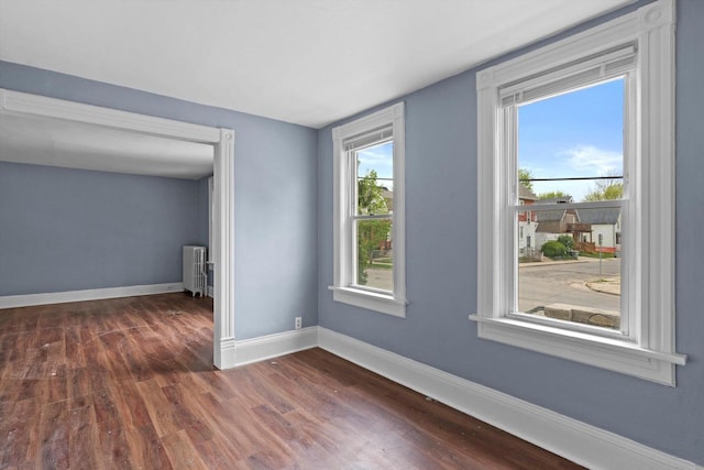 118 E Concordia Ave, Milwaukee, WI 53212 - empty room featuring radiator, dark wood-style floors, and baseboards