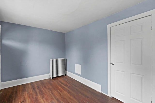 118 E Concordia Ave, Milwaukee, WI 53212 - unfurnished room with radiator heating unit, baseboards, and dark wood-style flooring