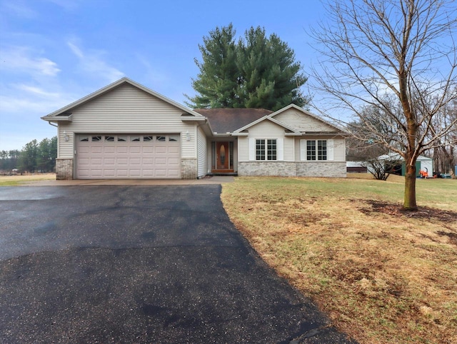 W11065 Menominee Rd, Portage, WI 53901 - ranch-style home with asphalt driveway, an attached garage, and a front yard