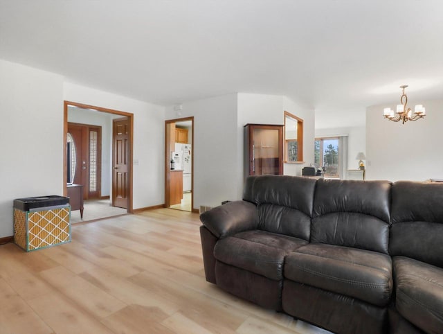 W11065 Menominee Rd, Portage, WI 53901 - living room featuring a chandelier, light wood finished floors, and baseboards