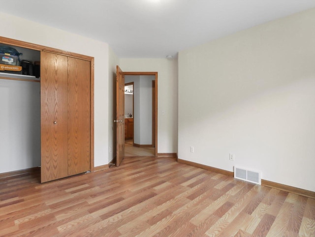 W11065 Menominee Rd, Portage, WI 53901 - unfurnished bedroom with light wood finished floors, a closet, and baseboards