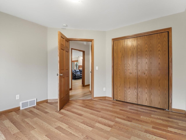 W11065 Menominee Rd, Portage, WI 53901 - unfurnished bedroom featuring light wood-type flooring, a closet, and baseboards