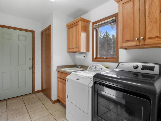 W11065 Menominee Rd, Portage, WI 53901 - laundry room with cabinet space, separate washer and dryer, and light tile patterned floors