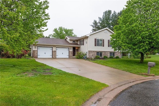 819 Fairway Cir, Black River Falls, WI 54615 - split level home with an attached garage, driveway, a front yard, and brick siding