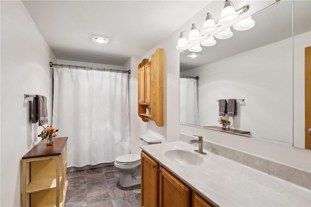 819 Fairway Cir, Black River Falls, WI 54615 - bathroom with vanity, toilet, stone finish floors, and curtained shower