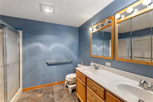 819 Fairway Cir, Black River Falls, WI 54615 - full bath with baseboards, toilet, an enclosed shower, and double vanity