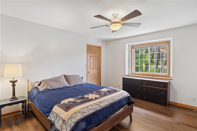 819 Fairway Cir, Black River Falls, WI 54615 - bedroom with wood finished floors, baseboards, and a ceiling fan