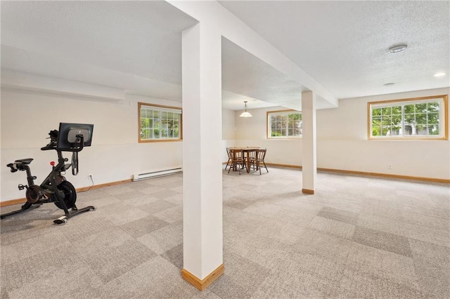 819 Fairway Cir, Black River Falls, WI 54615 - workout area featuring carpet floors, a baseboard heating unit, baseboards, and a textured ceiling