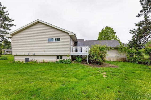 819 Fairway Cir, Black River Falls, WI 54615 - back of house featuring a lawn and a deck
