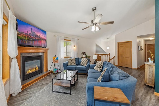 819 Fairway Cir, Black River Falls, WI 54615 - living area featuring ceiling fan, wood finished floors, a glass covered fireplace, vaulted ceiling, and baseboards